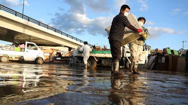 Residents remove muddy items from their flood-damaged homes in Koriyama, Fukushima. (Reuters)