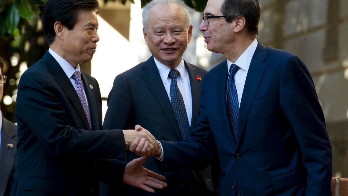 Treasury Secretary Steven Mnuchin shake hands with Chinese Commerce Minister Zhong Shan, left, before a minister-level trade meeting at the Office of the United States Trade Representative in Washington, Friday, Oct. 11, 2019. (AP Photo/Jose Luis Magana)