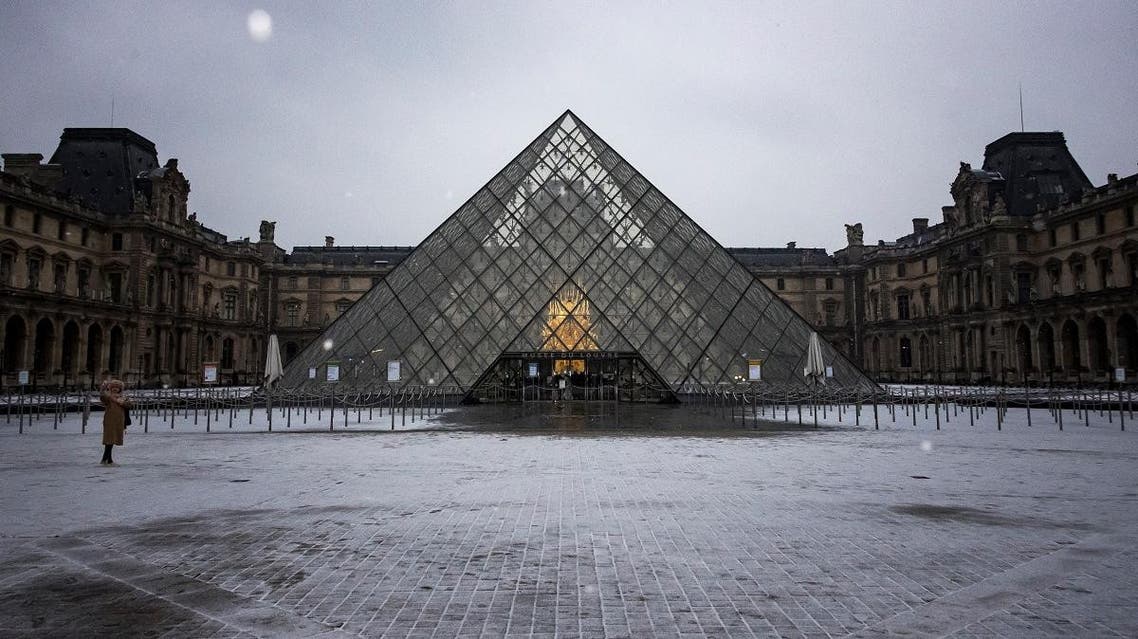 A tourist takes a selfie in front of the Louvre Pyramid in Paris on January 22, 2019. (AFP)
