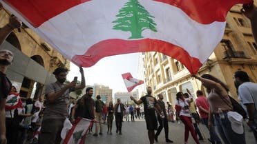 Protesters wave the national flag in downtown beirut as hundreds continued to gather on October 19, 2019 for a third day of protests. (AFP) 