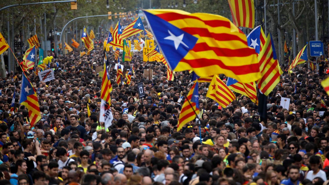 Protestors wave Estelada pro-independence flags during a demonstration in Barcelona, Spain, Friday, Oct. 18, 2019.