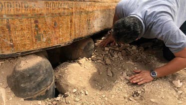 Oct. 15, 2019 file photo provided by the Egyptian Ministry of Antiquities shows Egyptian Minister of Antiquities Khaled el-Anany looking at recently discovered ancient colored coffins with inscriptions and paintings, in the southern city of Luxor, Egypt. (AP)