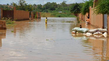 A child wades through water on a flooded street in the Kirkissoye quarter in Niamey on September 3, 2019. (AFP)