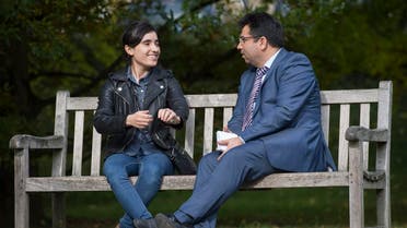 Lamia Haji Bashar (L) and Mirza Dinnayi, chairman of the "Luftbrücke Irak" (airlift Iraq), talk in a park in Stuttgart, southwestern Germany. (AFP)