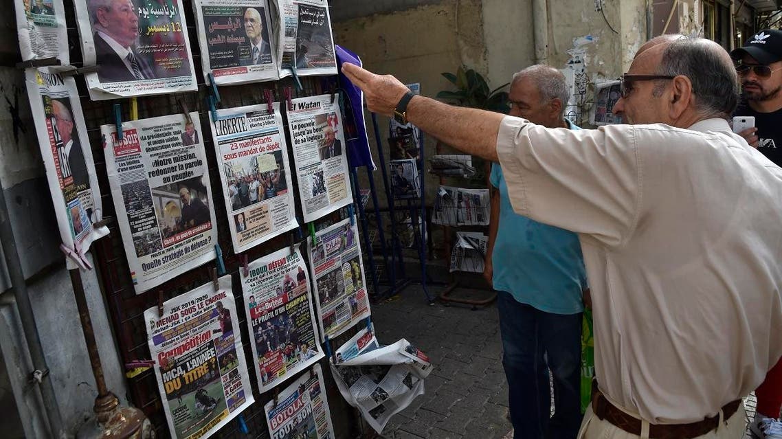 People view the covers of national and foreign newspapers, with the announced Algerian presidential election date dominating headlines, at a stand in Algeria's capital Algiers on September 16, 2019. (AFP)