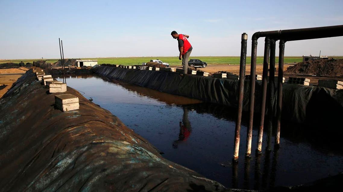 This April 6, 2018 photo shows a former farmer working at a primitive refinery making crude oil into diesel and other products, in a village controlled by a U.S-backed Kurdish group, in Rmeilan, Hassakeh province. (AP)