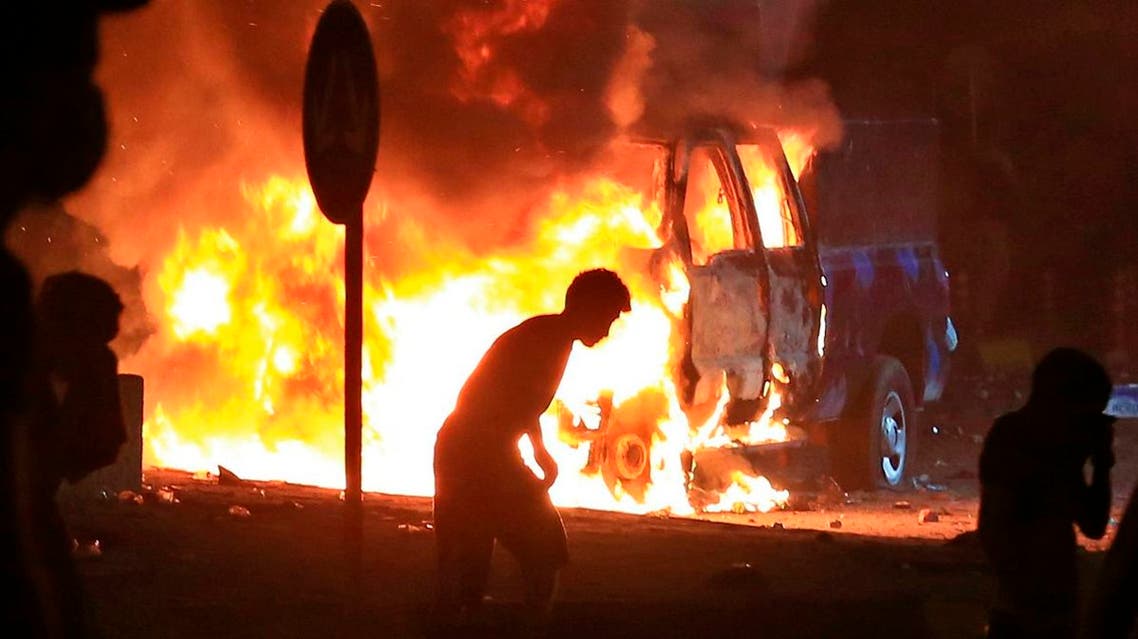Anti-government protesters burn police vehicles guarding the provincial council during a demonstration in Basra, Iraq. (AP)