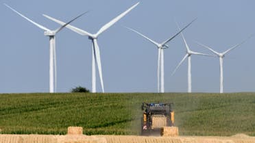 Wind turbines agriculture farming hay bales tractor Guigneville, central France - AFP