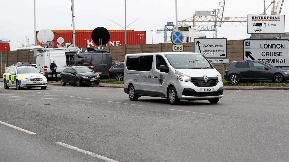 A vehicle of a funeral home, escorted by police, leaves the Port of Tilbury where the bodies of immigrants are being held by authorities. (Reuters)
