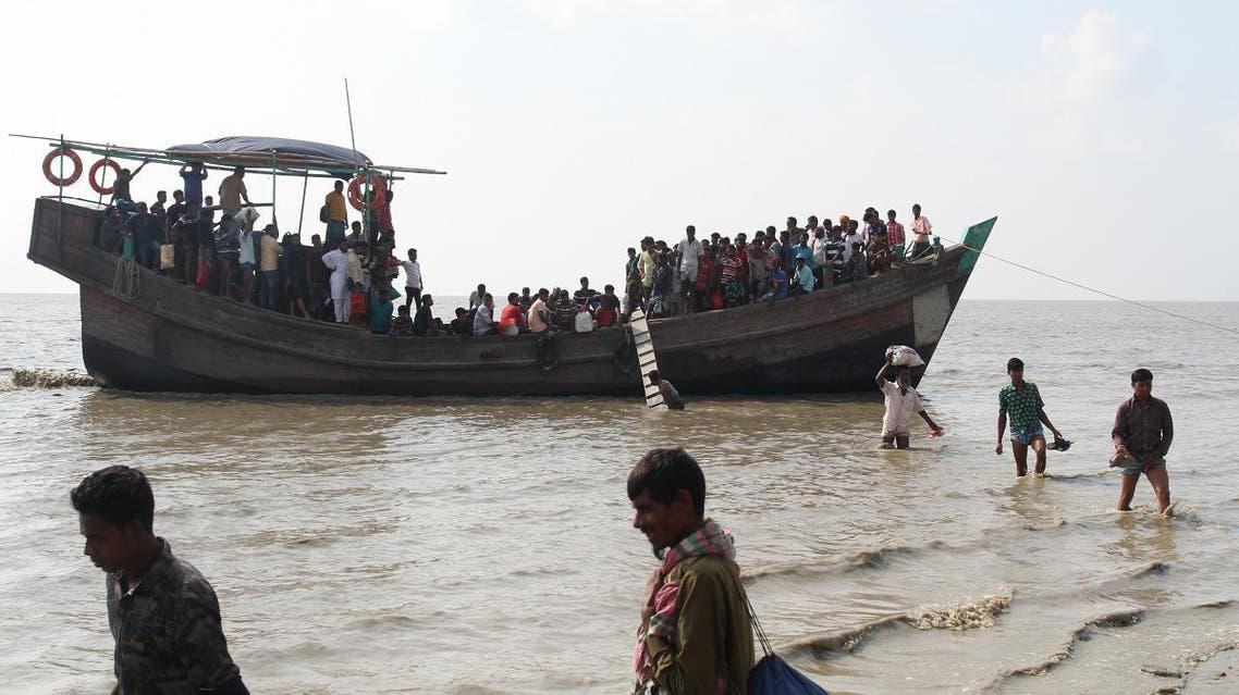 People get off a boat in Bhashan Char island off the Bangladeshi coast, as it was being prepared for the relocation of Rohingya refugees living in the country's south. (AFP)