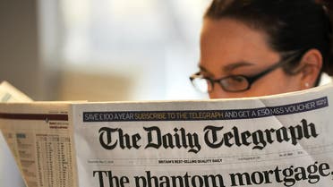A woman reads a copy of the Daily Telegraph newspaper in London, on May 21, 2009. (AFP)