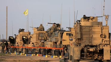  American soldiers stand near military trucks, at al-Omar oil field in Deir Al Zor on March 23, 2019. (Reuters)