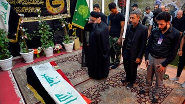 Mourners pray over the flag-draped coffin of a member of Iraq's Shiite Muslim Hashed al-Shaabi (Popular Mobilization units) paramilitary force during his funeral in the central holy shrine city of Najaf on October 26, 2019. (AFP)