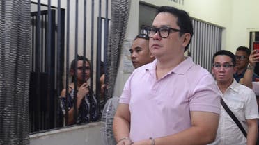 In this photo taken on October 24, 2019, Clarin town mayor David Navarro (in handcuffs) enters a police station after his arrest in Cebu. (AFP)