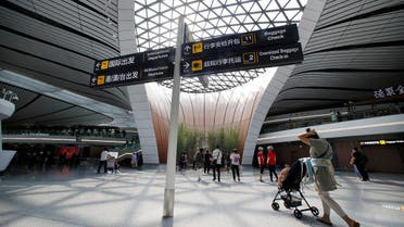 People walk at the terminal hall of the newly launched Daxing International Airport on the outskirts of Beijing. (Reuters)