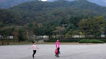 In this Oct. 23, 2018, photo, tourists walk through the empty parking lot of the Kumgansan Hotel at the Mount Kumgang resort area in North Korea. At the height of South Korea's policy of engagement with the North, the "Diamond Mountain Resort" area was a symbol of cooperation. (AP)