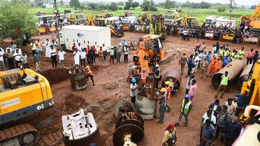 Rescue workers gather with heavy digging equipment during an operation to rescue a toddler stuck in a deep well near Manapparai town in Tiruchirappalli district (AFP)