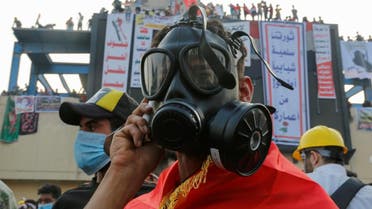 A demonstrator wears a mask to protect himself from tear gas during a protest over corruption, lack of jobs, and poor services, in Baghdad. (Reuters)