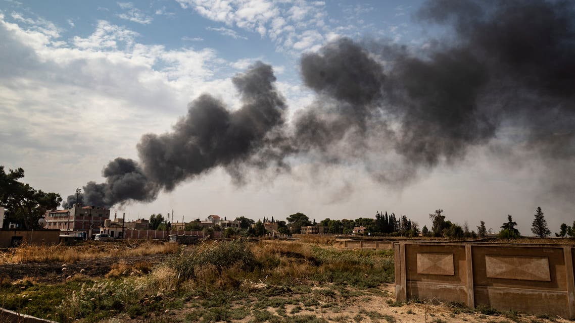 This picture taken on October 16, 2019, from the outskirts of the town of Tal Tamr near the Syrian Kurdish town of Ras al-Ain along the border with Turkey in the northeastern Hassakeh province, shows a large smoke plume from a tire fire billowing to decrease visibility for Turkish warplanes during the continuing deadly cross-border Turkish offensive against Syria's Kurdish forces that has sparked an international outcry.