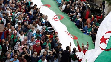Demonstrators carry national flags during a protest against the country's ruling elite and rejecting December presidential election in Algiers, Algeria, October 25, 2019. REUTERS