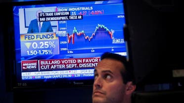 A screen displays the U.S. Federal Reserve interest rates announcement as traders work on the floor of the New York Stock Exchange (NYSE). (Reuters)