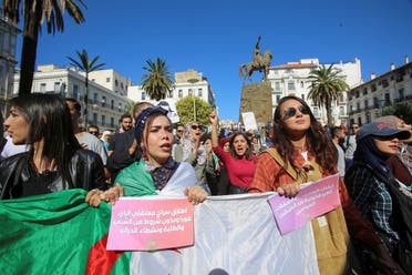 Demonstrators carry a national flag and banners during a protest against the country's ruling elite and to demand an end to corruption and the army's withdrawal from politics in Algiers, Algeria October 29, 2019. Picture taken October 29, 2019. REUTERS
