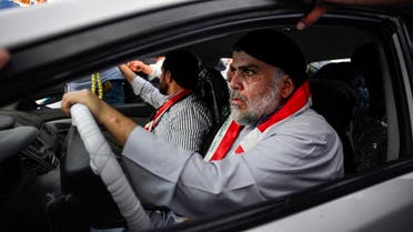 Moqtada al-Sadr (R) drives a car as he joins anti-government demonstrators gathering in the central holy city of Najaf on October 29, 2019. (AFP)
