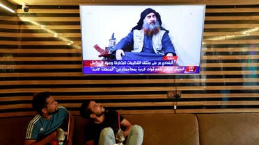 Iraqi youth watch the news of ISIS leader Abu Bakr al-Baghdadi death, in Najaf. (Reuters)
