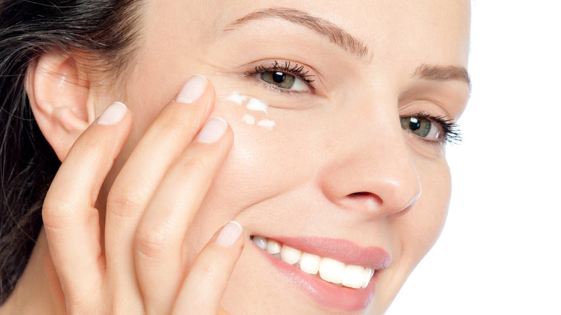 Skin care woman putting face cream stock photo