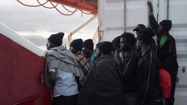 Men wait to disembark from the Ocean Viking ship as it reaches the port of Messina, Italy, Tuesday, Sept. 24, 2019. The humanitarian ship has docked in Italy to disembark 182 men, women and children rescued in the Mediterranean Sea after fleeing Libya. (AP Photo
