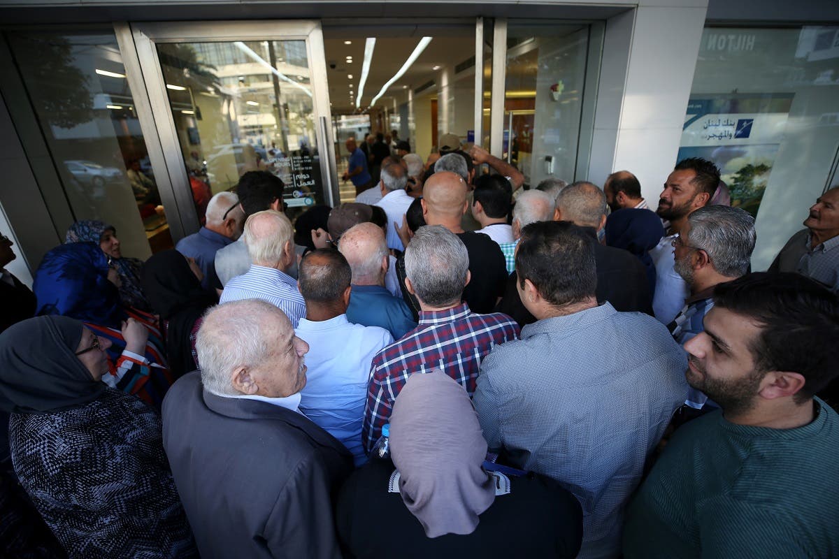 People queue outside a branch of Blom Bank in Sidon, Lebanon November 1, 2019. REUTERS