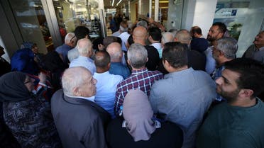 People queue outside a branch of Blom Bank in Sidon, Lebanon November 1, 2019. REUTERS