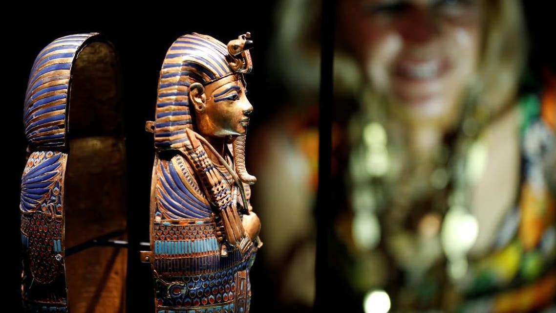 A woman looks at miniature canopic coffin during the media preview of "Tutankhamun: Treasures of the Golden Pharaoh" exhibition. (Reuters)