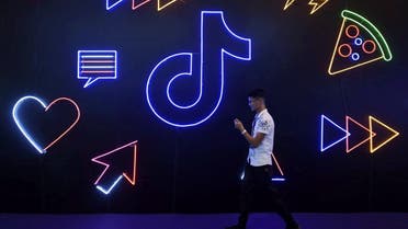 Man walks past a sign of ByteDance's app TikTok, known locally as Douyin, at an expo in Hangzhou. (Reuters)
