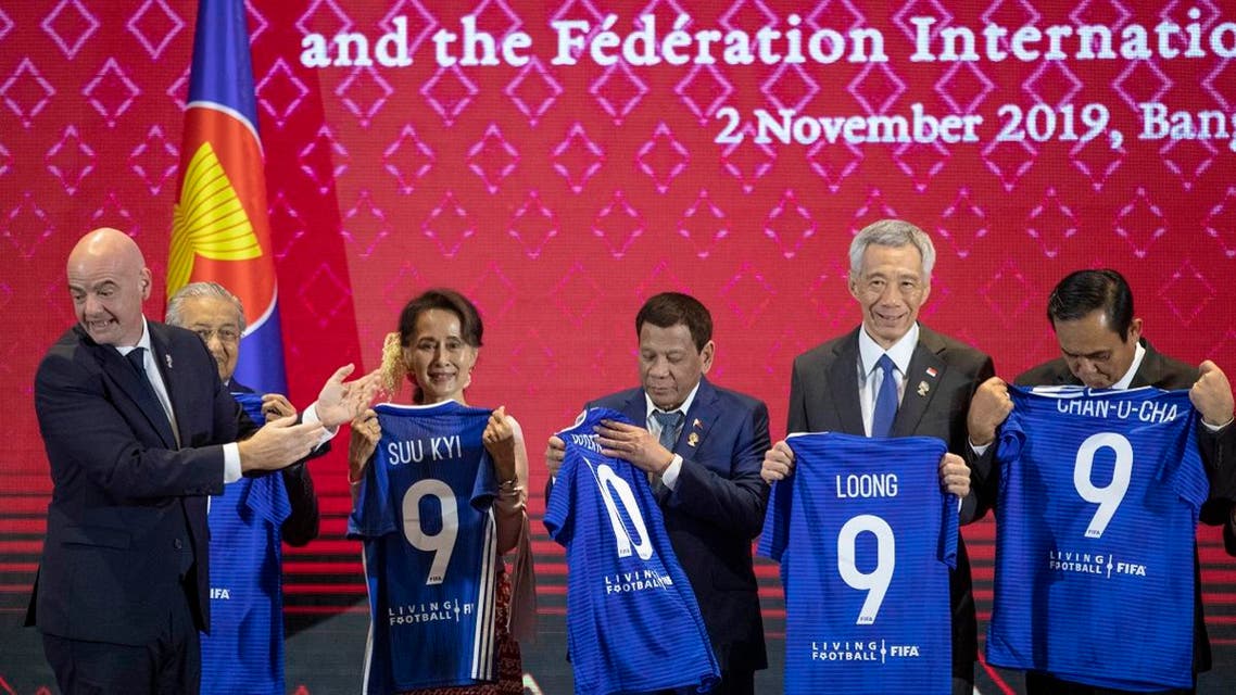 FIFA president Gianni Infantino (left), claps as ASEAN leaders hold soccer jerseys with their names during a ceremony to signing of memorandum of understanding between The ASEAN and FIFA in Nonthaburi, Thailand, on November2, 2019. (AP)