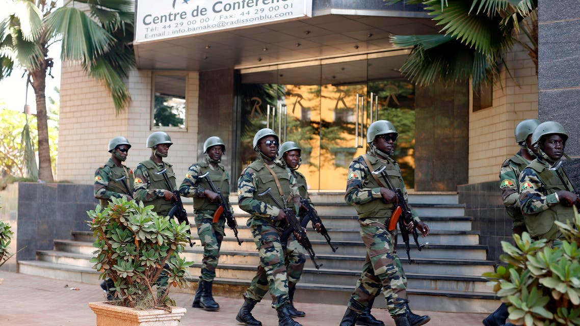 Nov. 21, 2015 file photo, soldiers from the presidential guard patrol outside the Radisson Blu hotel in Bamako after it was attacked by Islamic extremists armed with guns and grenades. (AP)