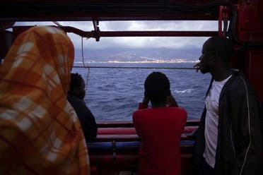 Migrants look at the Italian shoreline from aboard the Ocean Viking as it approaches the Sicilian port of Messina, southern Italy, on September 24, 2019. (AP)