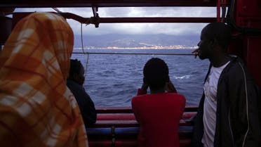 Migrants look at the Italian shoreline from aboard the Ocean Viking as it approaches the Sicilian port of Messina, southern Italy, Tuesday, Sept. 24, 2019. The Ocean Viking has docked in Sicily, Italy, to disembark 182 men, women and children rescued in the Mediterranean Sea after fleeing Libya. (AP)