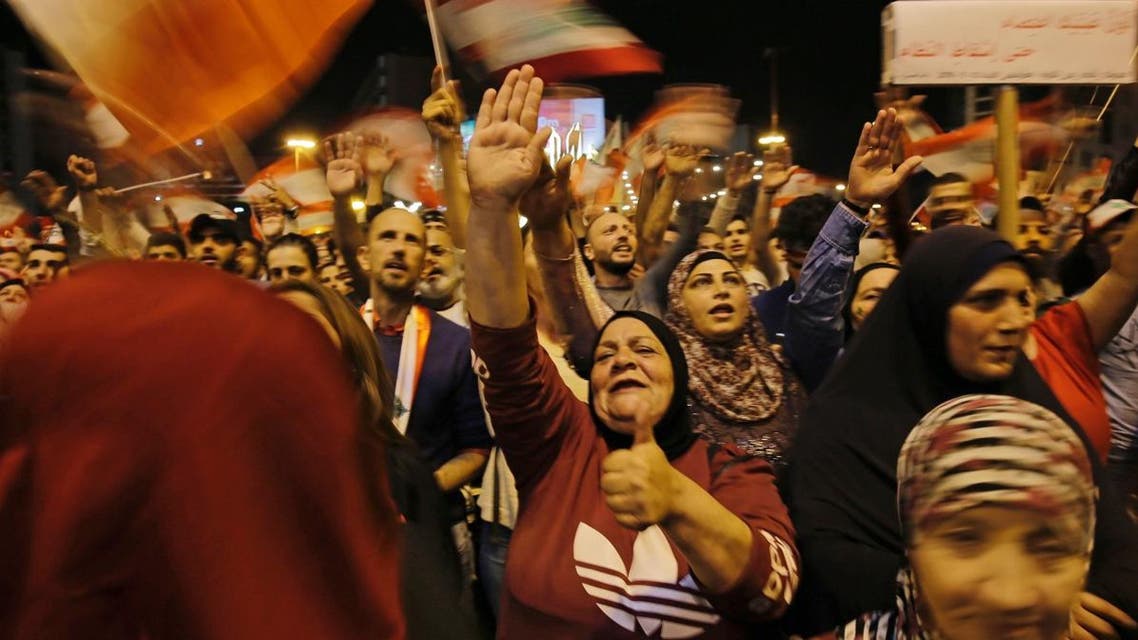 Lebanese protesters wave flags and shout slogans during an anti-government demonstration at al-Nour Square in the northern port city of Tripoli on November 2, 2019. (AFP)