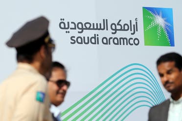 The logo of Aramco is seen as security personnel stand before the start of a press conference by Aramco at the Plaza Conference Center in Dhahran, Saudi Arabia November 3, 2019. (Reuters)
