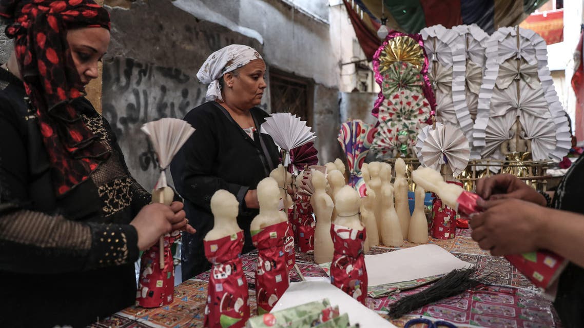 Egyptian women decorate traditional sugar statuettes in the capital Cairo on November 2, 2019, ahead of celebrations of the Muslim Prophet Mohammed's birthday, known as "Al Mawlid Al Nabawi". (AFP)
