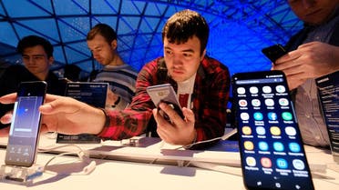 A man looks at Samsung smartphones during a presentation of the new Samsung Galaxy S8 at the Russian market of electronic devices in Moscow, on April 13, 2017. (AFP)