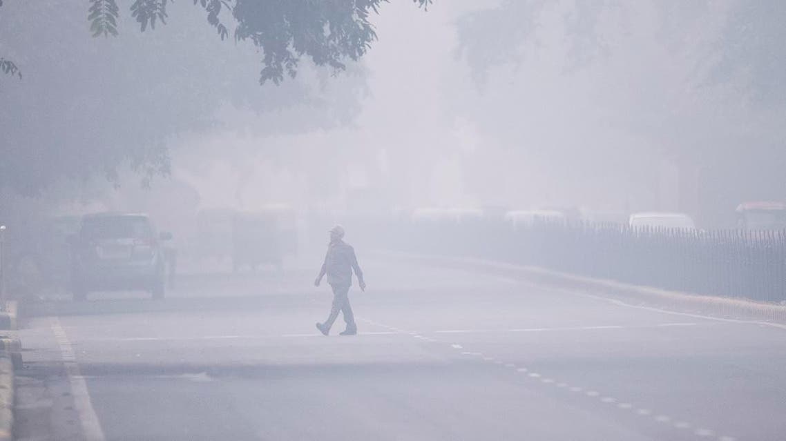 A man crosses a street in smoggy conditions in New Delhi on November 4, 2019. (AFP)