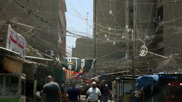 A random web of elctric wires dangle above a market street in the Iraqi capital Baghdad's Bab Al-Seef neighbourhood. (AFP)