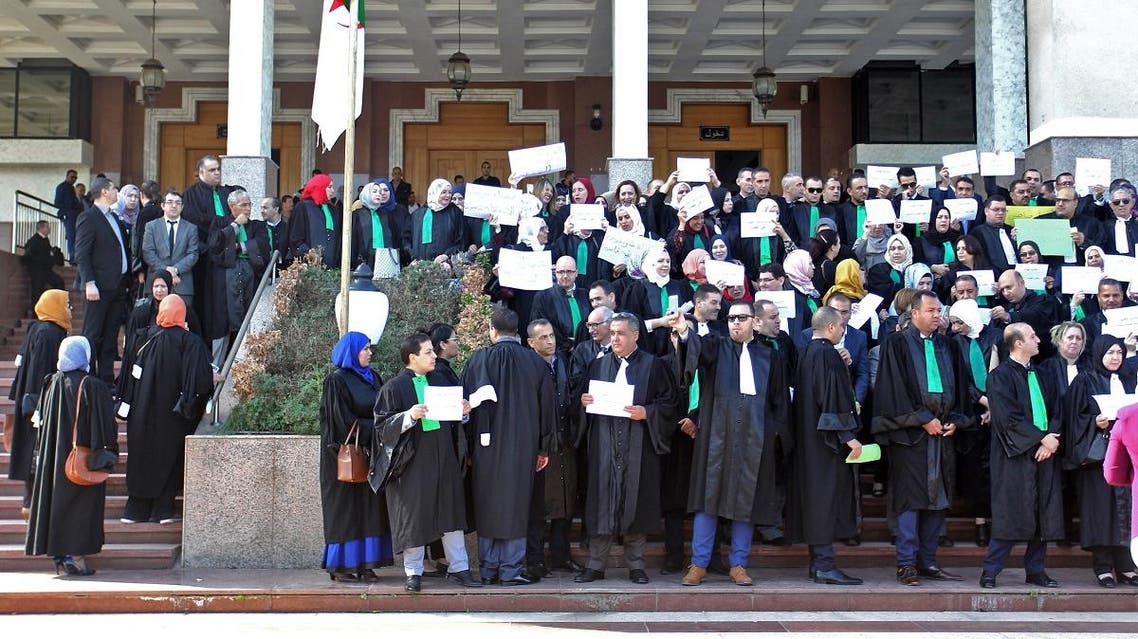 Algerian judges and prosecutors lift placards during a protest in front of the judicial council in the capital Algiers on October 29, 2019. (AFP)