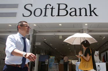 People walk by a SoftBank shop in Tokyo. (AP)
