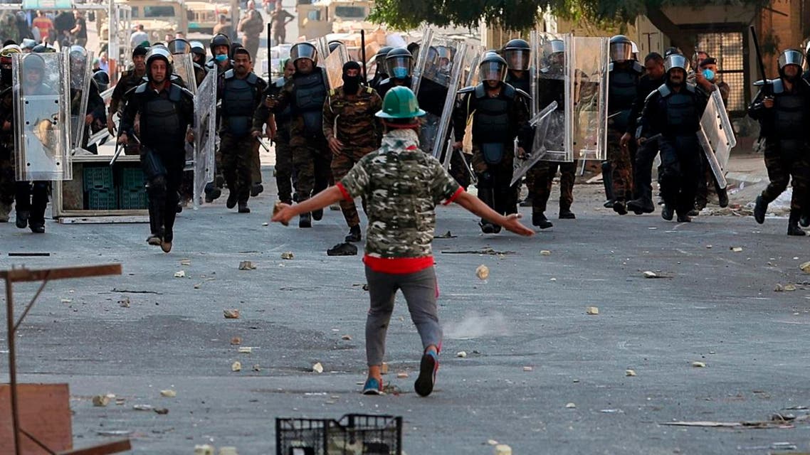 Iraqi anti-riot police try to prevent anti-government protesters from crossing the al- Shuhada (Martyrs) bridge in central Baghdad. (Reuters)