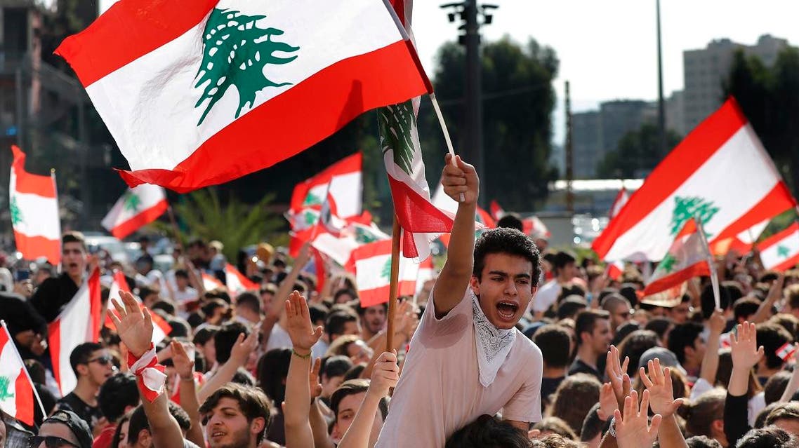 Student protesters wave national flags as they protest against the government in front of the education ministry in Beirut, Lebanon, on November 7, 2019. 