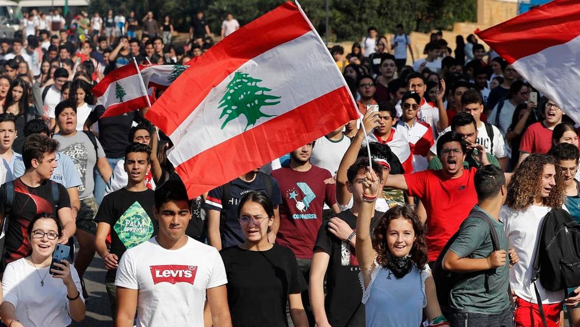 Student protesters wave their national flags and shout slogans, as they protest against the government in front of the education ministry in Beirut, Lebanon, on Nov. 8, 2019. (AP)