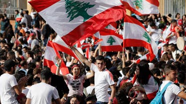 Student protesters wave their national flags as they protest against the government in front of the education ministry in Beirut, Lebanon, Friday, Nov. 8, 2019. (AP)